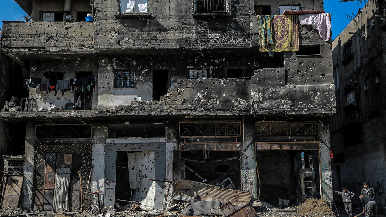 A man digs outside a damaged building in Gaza City on February 11, 2024, amid ongoing battles between Israel and the militant group Hamas. (Photo: AFP)