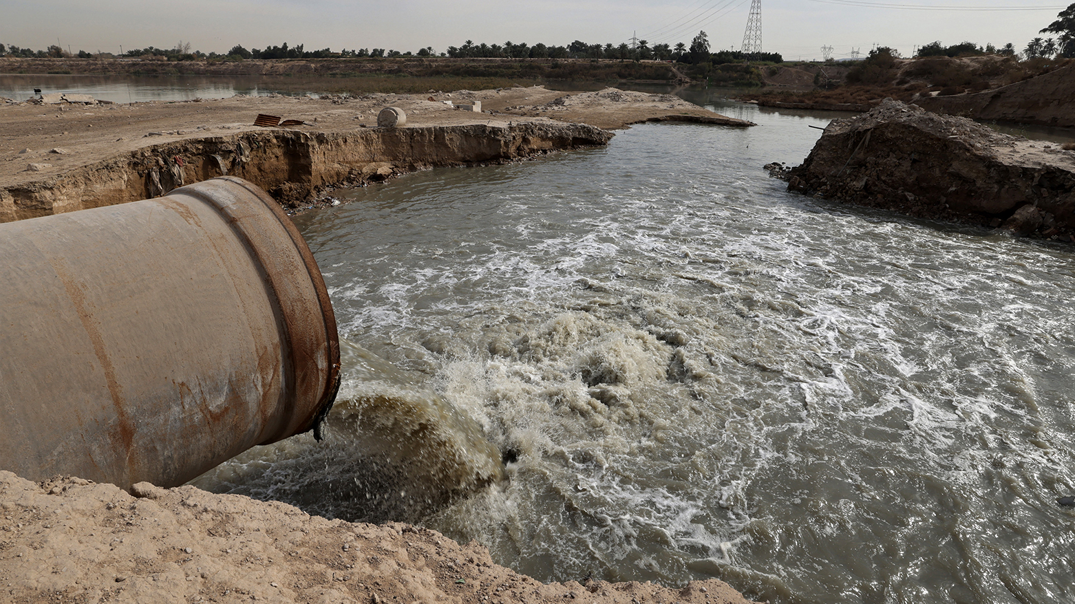 A picture shows a pipe pouring sewage into the Diyala River, east of Baghdad, on January 21, 2024. (Photo: AFP)