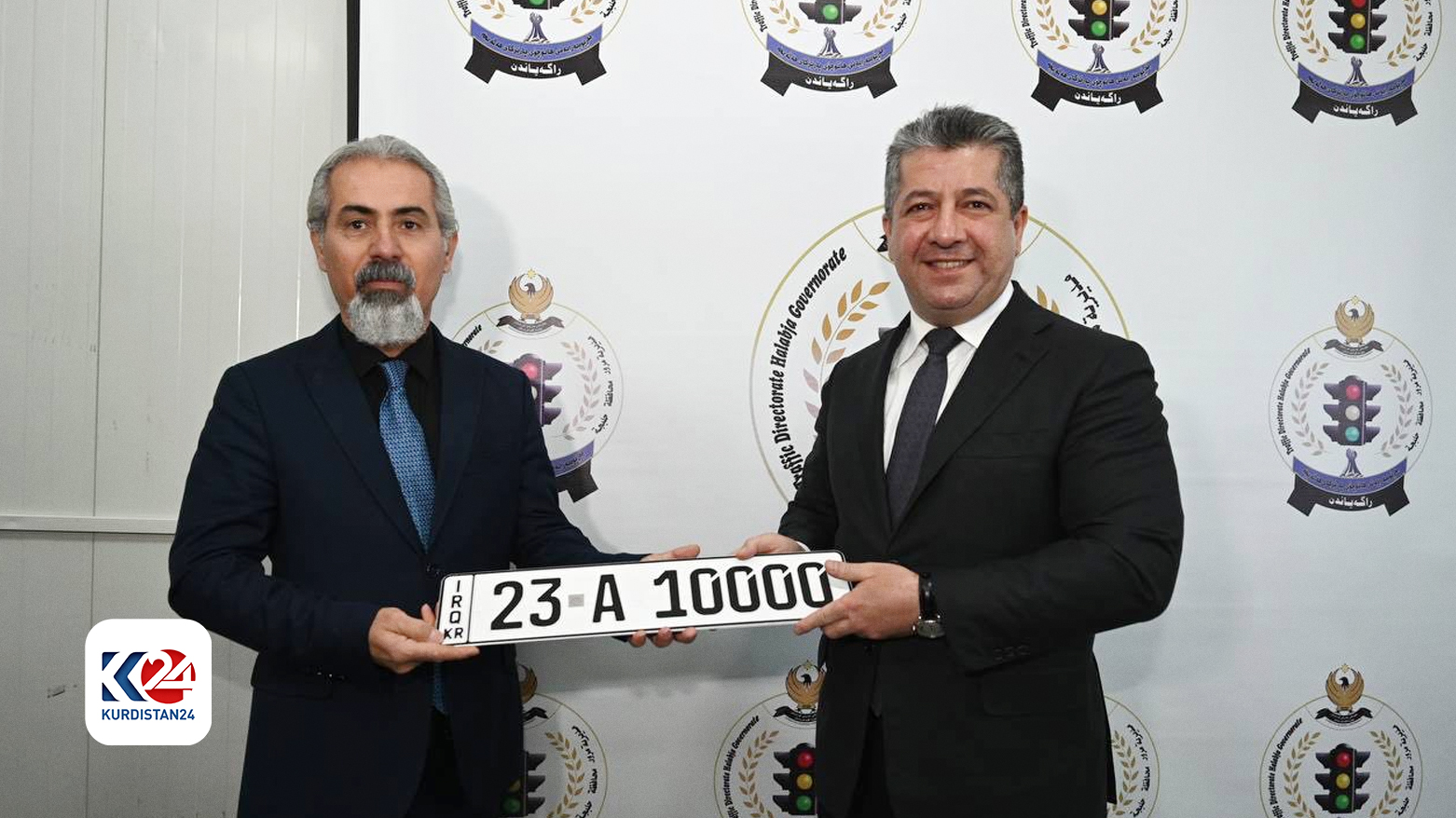 Kurdistan Region Prime Minister Masrour Barzani (right) presenting the first number plate Halabja, Feb. 22, 2024. (Photo: KRG)