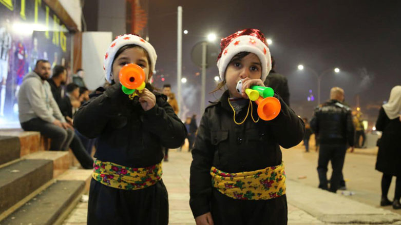 Two Kurdish children pose for a photo during New Year'e Eve celebrations in the Kurdistan Region's city of Sulaimani, Dec. 31, 2020. (Photo: Kurdistan 24/Dana Hama Gharib)
