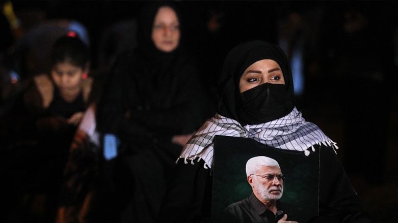 Supporters of the Hashed al-Shaabi hold a candlelight vigil at the site of the January 3, 2020 US drone strike on Qasem Solemani, Jan. 2, 2021. (Photo: Ahmad al-Ruabye / AFP)