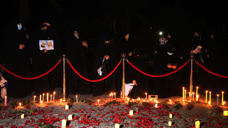 Supporters of the Hashed al-Shaabi hold a candlelight vigil at the site of the January 3, 2020 US drone strike on Qasem Solemani, Jan. 2, 2021. (Photo: Ahmad al-Ruabye / AFP)