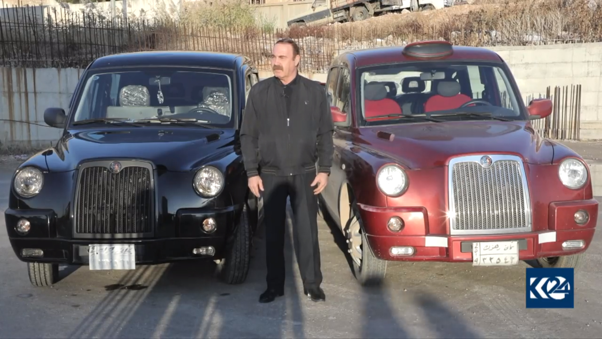 Haji Amjed stands between his cabs in Kurdistan Region's Duhok province. (Photo: Kurdistan 24)