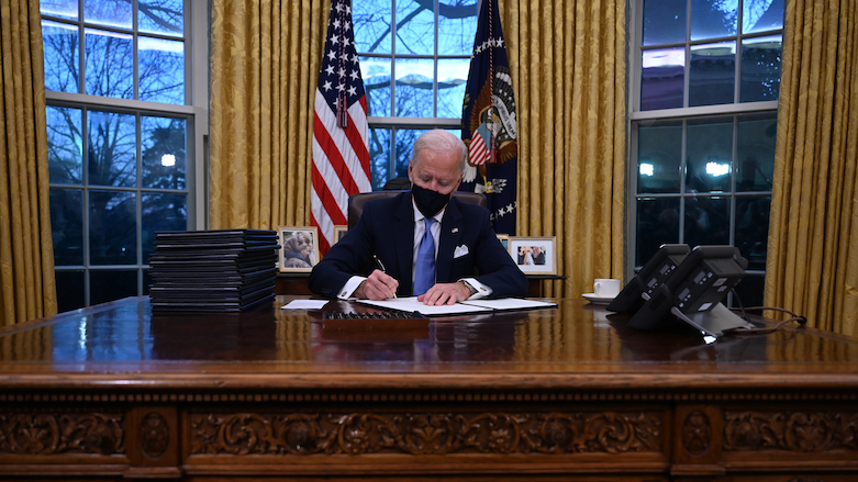 US President Joe Biden signs a series of orders in the Oval Office of the White House in Washington, DC, after being sworn in at the US Capitol on Jan. 20, 2021. (Photo: AFP/Jim Watson)
