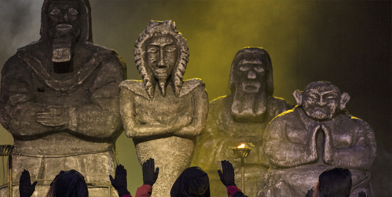 Actors perform before idols as they play out a scene depicting pre-Islamic Arabian rituals from a theatrical production titled 