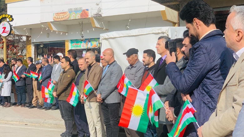 Sirye residents attend flag raising ceremony.