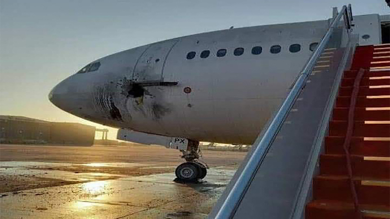 a damaged stationary aircraft on the tarmac of Baghdad airport, after rockets reportedly targeted the runway, on Jan. 28, 2022. (Photo: AFP Photo/ Ho/ Facebook Page of the Iraqi Ministry of Transportation)