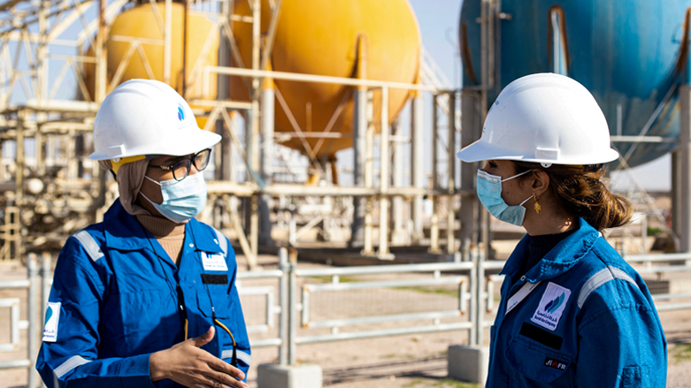 Safa al-Saeedi, 29, (R) and Dalal Abedlamir, 24, two of 180 women among the 5,000 employees of the Basrah Gas Company near the southern Iraqi city of Basra, speak to each other, on Jan. 20, 2022. (Photo: Hussein Faleh/AFP)