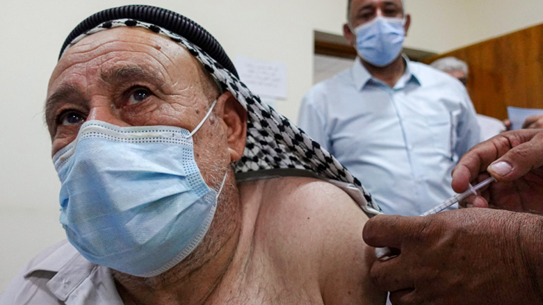 An Iraqi man is inoculated against the COVID-19 coronavirus at a vaccination center of Kufa, northeast of Najaf, July 25, 2021. (Photo: Ali Najafi/AFP)