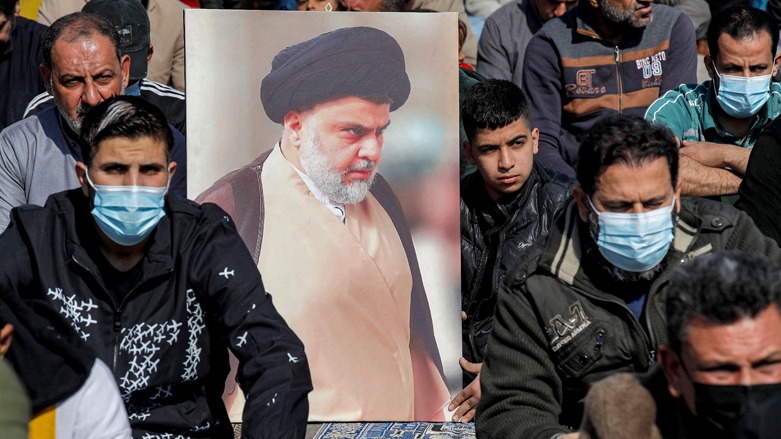 Supporters of Iraqi Shiite Muslim cleric Muqtada al-Sadr hold a portrait of the leader while performing the weekly Friday prayers in the Sadr City suburb of Iraq's capital Baghdad on Jan. 28, 2022.  (Photo:Ahmad al-Rubaye/AFP)
