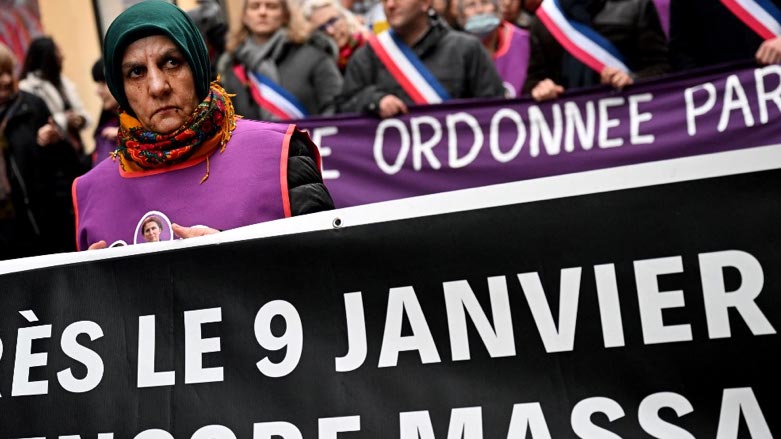 Protestors hold slogans during a tribute march in Paris on January 4, 2023, in the memory of three Kurdish activists, who were murdered in January 2013 (Photo: Emmanuel Dunand/AFP)