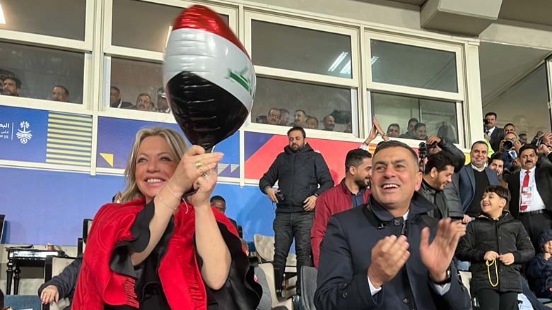 UN envoy to Iraq, Jeanine Hennis-Plasschaert (left), holding a heart-shaped balloon on which the Iraq flag is printed, cheering for the Iraqi national team against Saudi Arabia, Jan. 9, 2022. (Photo: UNAMI/Twitter)