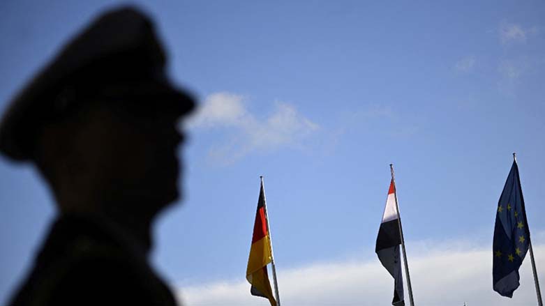 An officer stands by as the flags for (LtoR) Germany, Iraq and Europe fly during an official welcome ceremony for Iraq's Prime Minister at the Chancellery in Berlin. Jan. 13, 2023. (Photo: Tobias Schwarz/AFP)