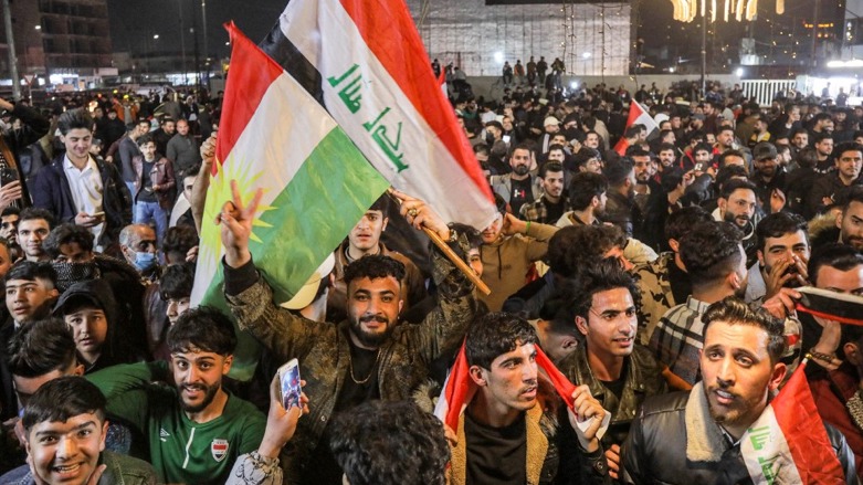 Football fans wave the flags of Kurdistan and Iraq as they celebrate the Iraqi national team's victory against Oman in Erbil on Jan 19, 2023 (Photo: Safin Hamed/AFP)