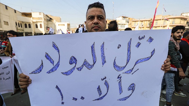 A man stands holding a sign reading in Arabic "depreciate the rate of the [US] dollar, or else..!" during a protest against the depreciation of the Iraqi dinar against the US dollar in Baghdad, Jan. 25, 2023. (Photo: Ahmad Al-Rubaye/AFP)
