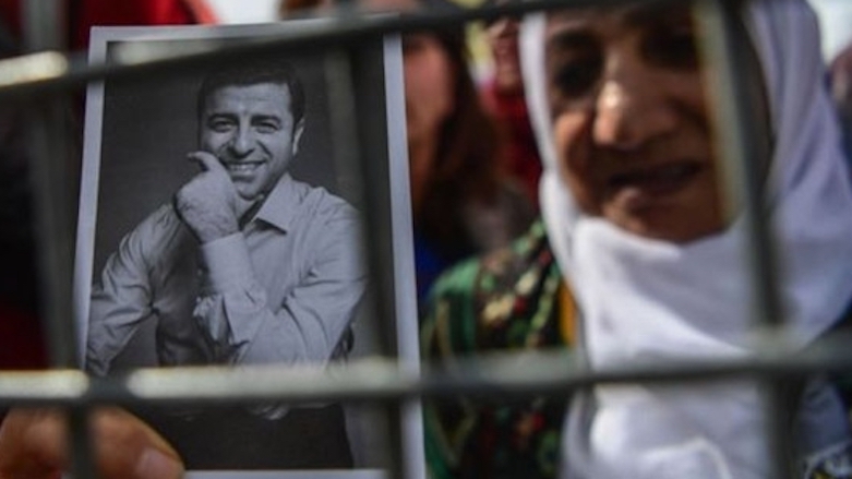 A supporter of Selahattin Demirtas displays an image of the former HDP co-chair in Istanbul (Photo: AFP)