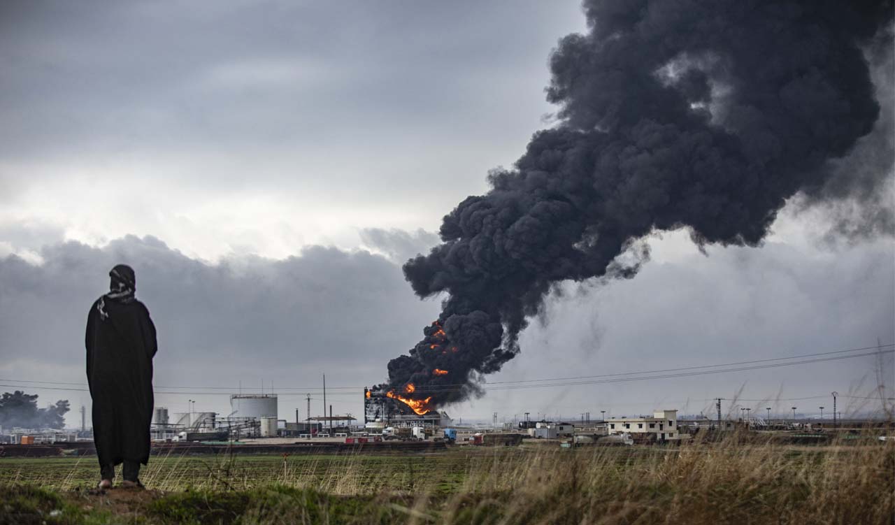 Thick smoke billows from a raging fire at a storage tank of the al-Awda oil field facility near al-Qahtaniyah in northeastern Syria close to the Turkish border, Dec. 24, 2023. (Photo: Delil Souleiman/AFP)
