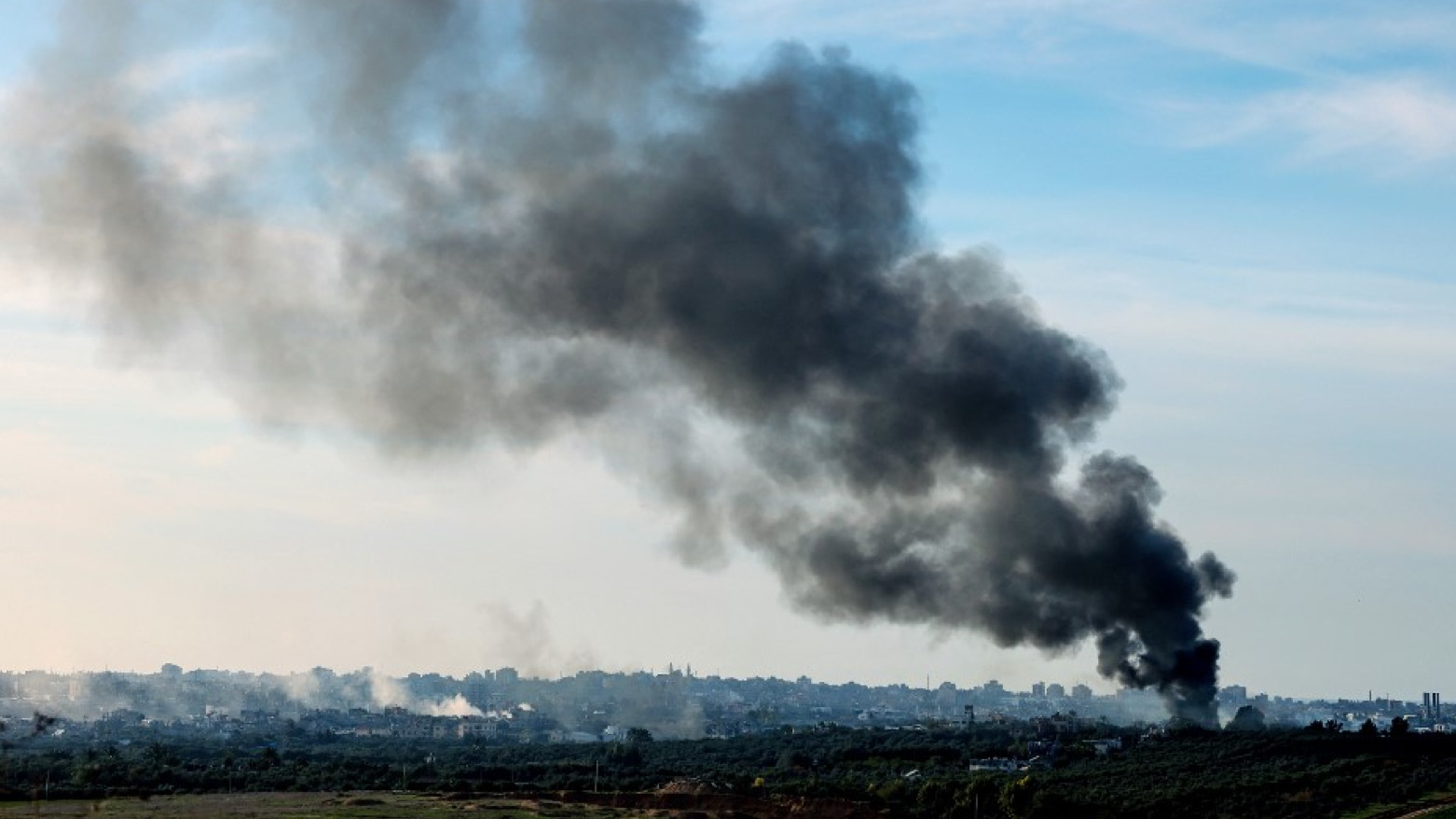 A picture taken from southern Israel on the border with the Gaza Strip shows smoke billowing over the Palestinian territory during Israeli bombardment on January 18, 2024 (Photo: JACK GUEZ/AFP)