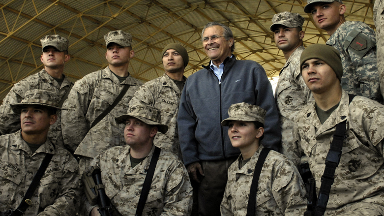 US Secretary of Defence Donald Rumsfeld posing with troops assigned to Al-Asad Air Base in Iraq's restive Al-Anbar province, Dec. 9, 2006. (Photo: Cherie a Thurlby/ DOD/ AFP)