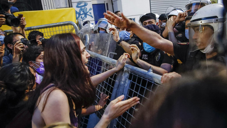 A protester confronts police officers preventing the group from marching against the Turkish government’s decision to withdraw from Istanbul Convention, in Istanbul, July 1, 2021. (Photo: Kemal Aslan/AP)