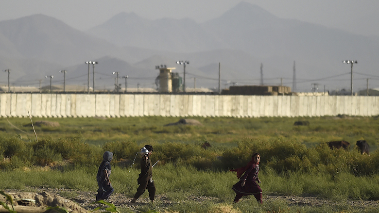 Children walk along a path outside a US military base in Bagram, north of Kabul, Afghanistan on July 1, 2021. (Photo: Wakil Kohsar/AFP)