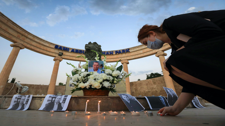 During the evening in Erbil city, a lady lights a candle to honor the death of Hisham al-Hashimi, July 11, 2020. (Photo: AFP/Safin Hamed)
