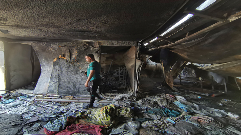 A man looks around at the ravaged coronavirus isolation ward of Al-Hussein hospital after a massive fire engulfed it in the southern Iraqi city of Nasiriyah, July 13, 2021. (Photo: Asaad Niazi/AFP)