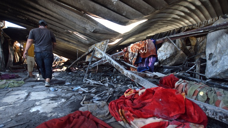Workers search the rubble of a coronavirus isolation ward of al-Hussein Hospital in the Iraqi city of Nasiriyah after being destroyed by a deadly fire overnight, July 13, 2021. (Photo: AFP/Asaad Niazi)