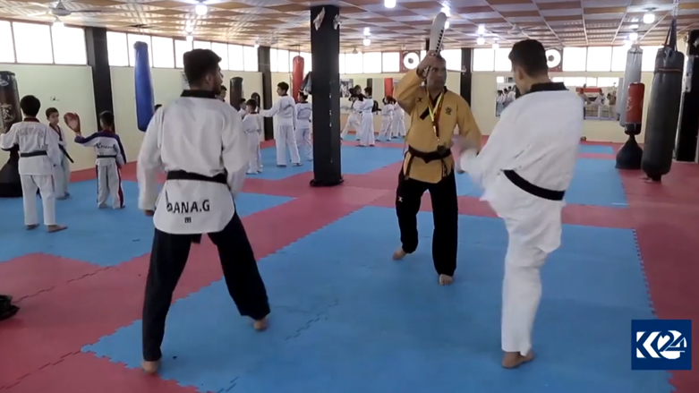 Goran Abdul Qadir, Taekwando coach, trains his sons. (Photo: Kurdistan 24)