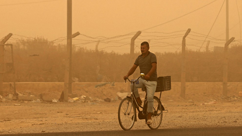 A man reacts as he rides his bicycle during a sandstorm in the town of Khalis, in Iraq's Diyala province, July 3, 2022. (Photo: Ahmad Al-Rubaye/AFP)