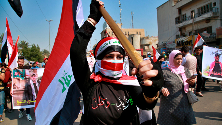 An anti-government protester holds the Iraqi flag during demonstrations in Baghdad, Iraq, Feb. 23, 2020. (Photo: Khalid Mohammed/AP)