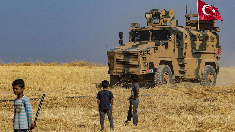 Syrian boys watch as a Turkish military vehicle patrol on Oct. 4, 2019 (Photo: Delil Souileman/AFP via Getty Images)