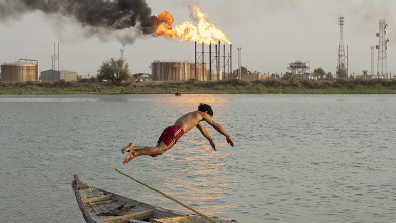 An Iraqi dives into the Shatt al-Arab river across from the Nahr Bin Omar oilfield in Iraq's southern province of Basra, July 18, 2022. (Photo: Hussein Faleh/AFP)