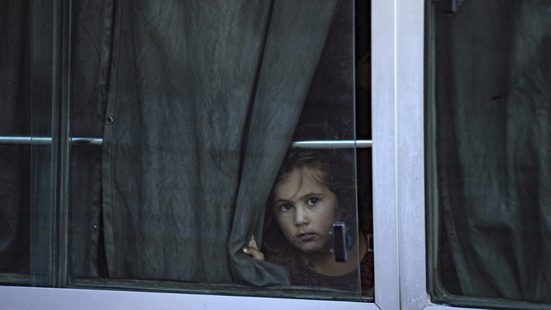 Women and children from families of Islamic State fighters sit in buses after Kurdish authorities handed them over to Tajikistan in Syria's Kurdish-majority city of Qamishli in the northeastern Hasakeh province, July 25, 2022. (Photo: Delil