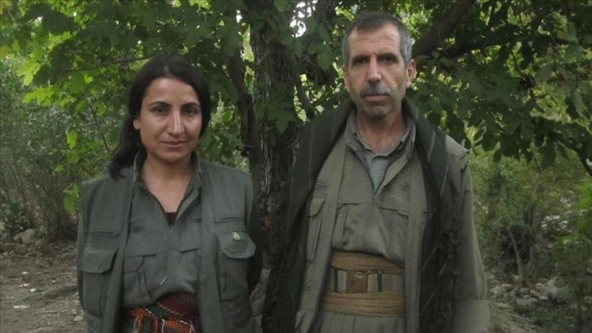 Hatice Hezer (left) wearing military fatigues poses for a photo with another militant (Photo: Anadolu Agency)