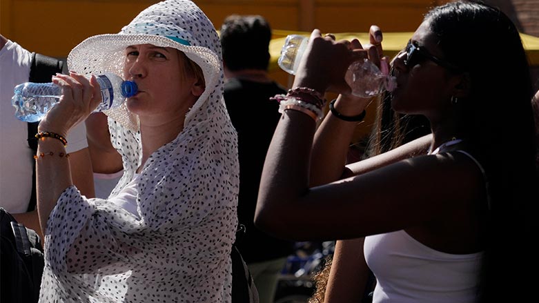 Tourists sips cold water as they shelter from a hot sunny afternoon near the Rome's Colosseum, July 5, 2023. (Photo: AP/Gregorio Borgia)