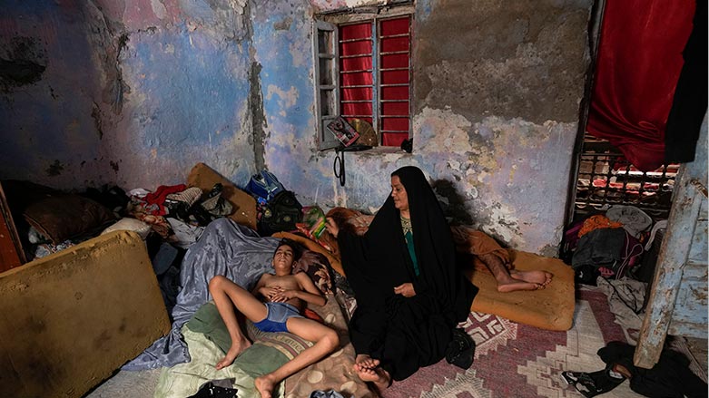 A Iraqi woman fans her child during a power outage at their home in Baghdad, Iraq, July 6, 2023. (Photo: AP/Hadi Mizban)