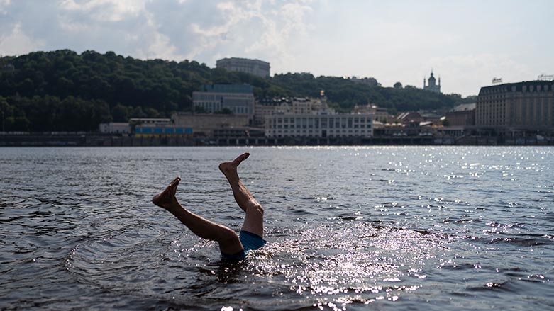 A man does a flip while cooling off in the Dnieper River in Kyiv, Ukraine, July 6, 2023. The planet's temperature spiked on Tuesday to its hottest day in decades and likely centuries. (Photo: AP/Jae C. Hong)