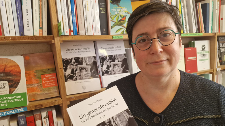 Béatrice Dillies, author of A forgotten genocide, the broken voice of the Kurdish people book, holds a copy of the book. (Photo: Courtesy of Béatrice Dillies)