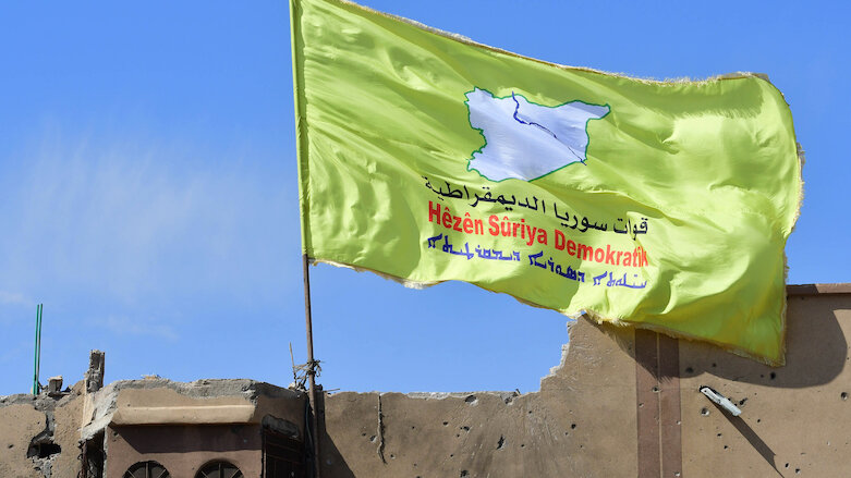 A banner of the Syrian Democratic Forces (SDF) is flown in northeastern Syria (Photo: Giuseppe Cacace/AFP)