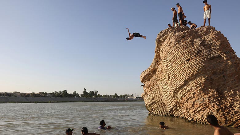An Iraqi dives into the waters of the Tigris river in Baghdad on July 12, 2023, as temperatures soared past 45 degrees Celsius. (Photo: Ahmed AL-Rubay/ AFP)