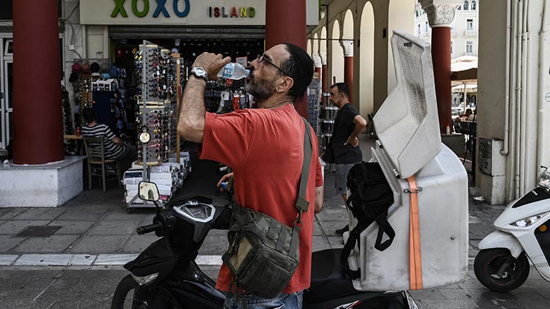 A delivery man drinks water in Thessaloniki on July 14, 2023, as Greece is hit by a heatwave. (Photo: Sakis Mitrolidis/ AFP)