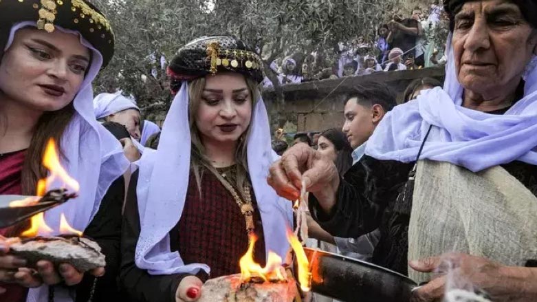 Yezidis light candles during a ceremony marking their New Year outside the Temple of Lalish near Duhok on April 18, 2023 (Photo: Safin Hamed/AFP)