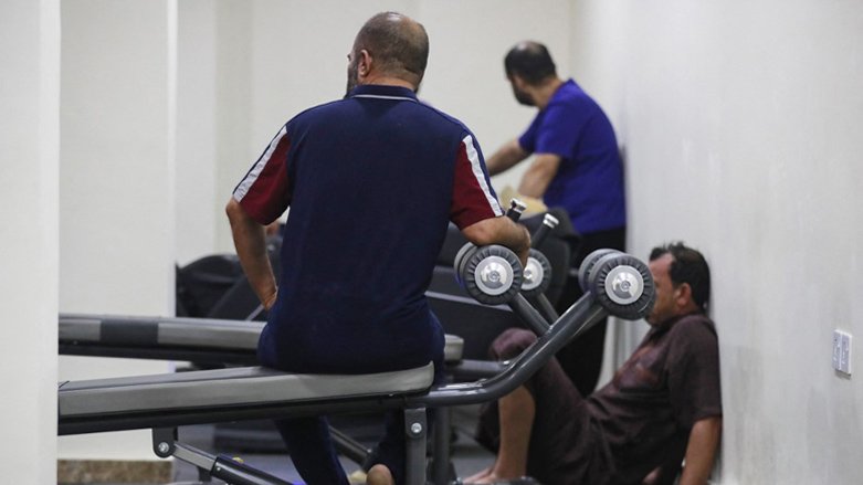 A patient exercises as others rest at the Al-Canal Center for Social Rehabilitation in Baghdad, July 11, 2023. (Photo: Ahmad Al-Rubaye/AFP)