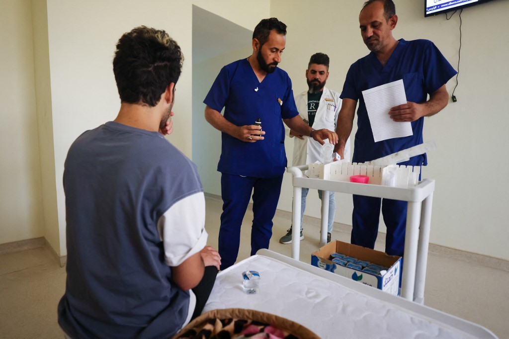 A patient waits to receive his doze of medication from health workers at the Al-Canal Center for Social Rehabilitation in Baghdad, July 11, 2023. (Photo: Ahmad Al-Rubaye/AFP)