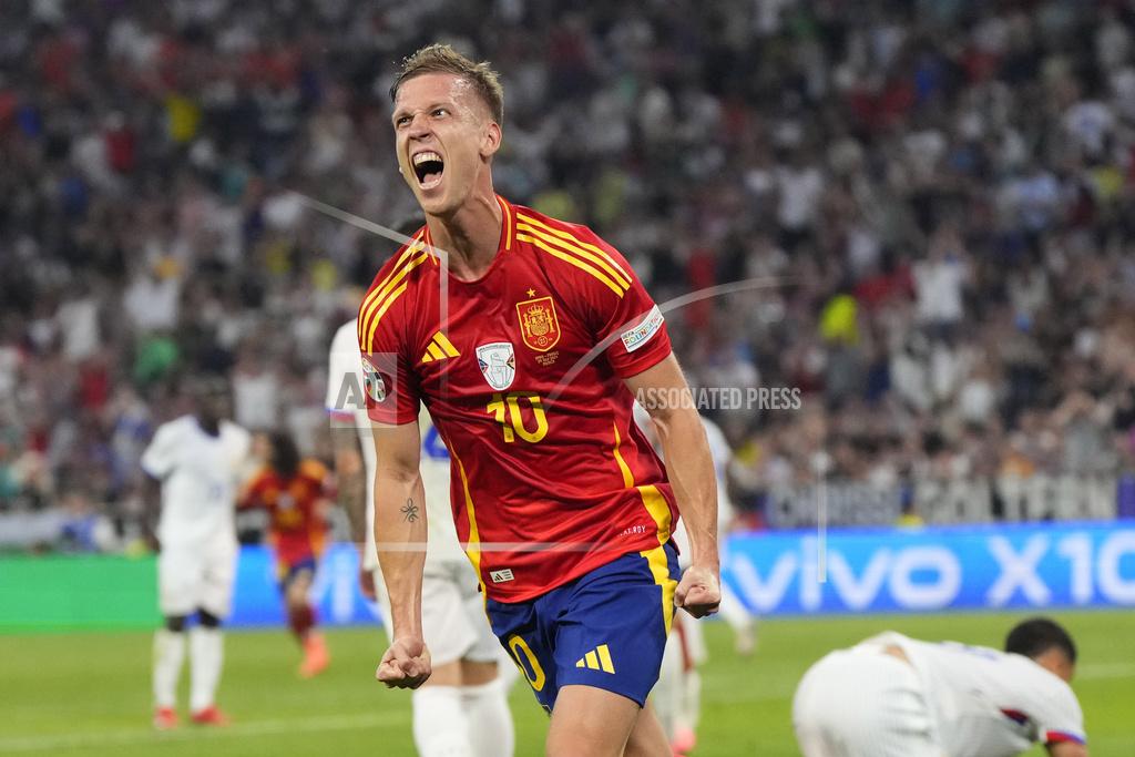 Spain's Dani Olmo celebrates after scoring his side's second goal during a semifinal match between Spain and France. (Photo: AP) 
