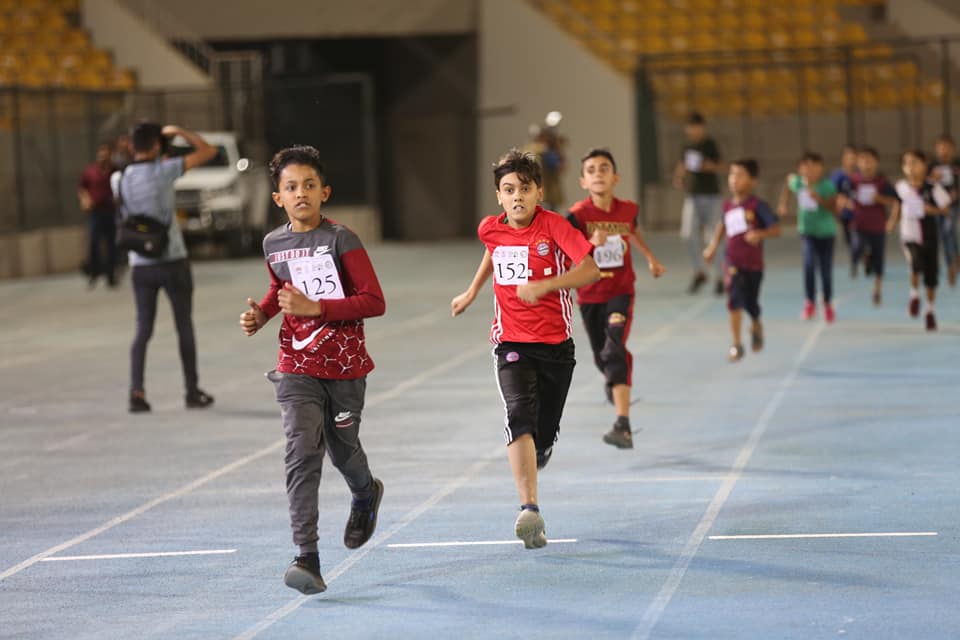 A group of kids run at Franso Hariri International Stadium as part of a marathon held on the International Children's Day, June 1, 2021. (Photo: Erbil Governorate)