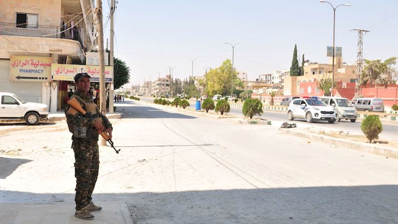 A Manbij Military Council member provides security outside local businesses during Eid al-Adha in Manbij, Syria, August 21, 2018. (Photo: Sgt. Nicole Paese/US Army)
