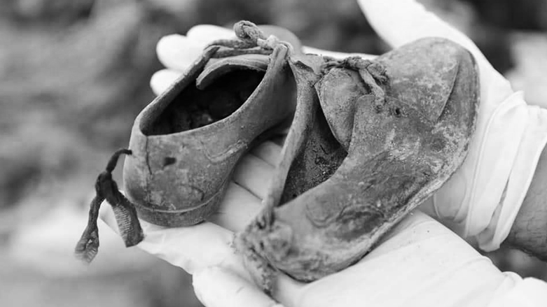Pair of shoes belonging to a Kurdish child who was buried with his family and dozens of citizens 38 years ago in a mass grave in Al-Muthanna province. (Photo: Kurdistan 24)