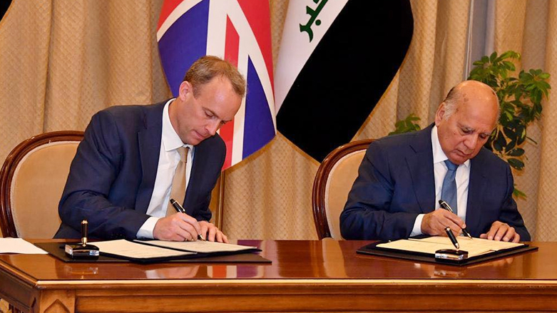 Iraqi Foreign Minister Fouad Hussein and his British counterpart Dominic Raab sign a document on political and strategic understanding between the two countries, June 8, 2021. (Photo: Iraqi Ministry of Foreign Affairs)